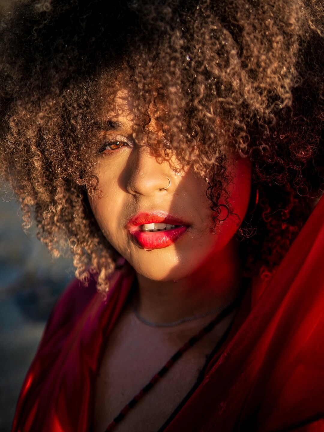 Portrait of a smiling Brazilian woman with curly hair looking confident